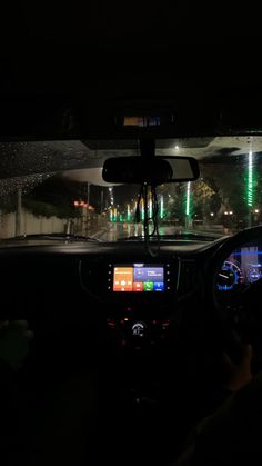 the interior of a car at night, with lights on and in the dash light