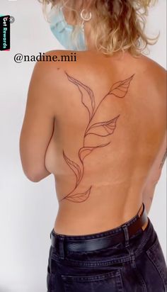 the back of a woman's body with tattoos on her upper and lower half