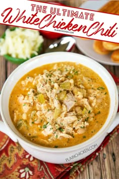 the ultimate white chicken chili in a bowl with bread and other food on the side