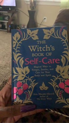 the witch's book of self - care is held up in front of a television