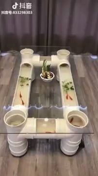 the table is made out of plastic cups and bowls with food in them on it