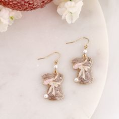 Gold tone shepherd hook earrings featuring enamel rabbit charms with pearl accents. These sweet Easter bunny charms measure about 1 inch in height. Rabbit Earrings, Rabbit Charm, Shepherds Hook, Collegiate Style, Bunny Earrings, Stretch Ring, Rose Jewelry, Pin Pendant, Earring Sale