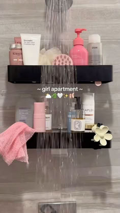 the shower head is connected to two shelves with soaps, shampoo and other items