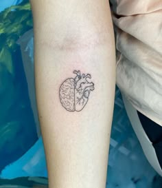 a small heart and brain tattoo on the arm