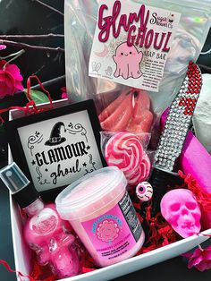 a box filled with lots of pink stuff next to a sign and other items in it