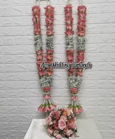 wedding bouquets are arranged on top of a table in front of a brick wall