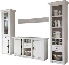 a white entertainment center with shelves and drawers