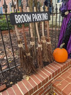 brooms are placed in front of a sign that says broom parking