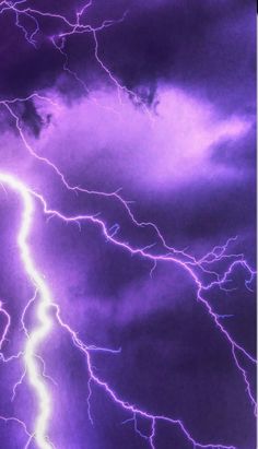 purple lightning strikes across the night sky