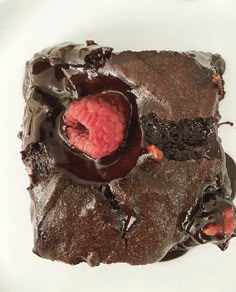 a piece of chocolate cake with a raspberry on top