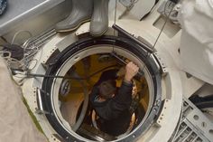 a man working on the inside of a space station