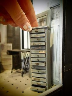 a woman's hand reaching for an old drawer