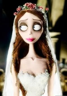 the corpse bride doll is dressed in white and has red flowers on it's head