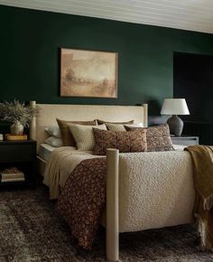 a bedroom with green walls and white bedding