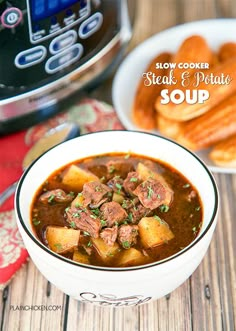 a bowl of beef stew with french bread in the background and text overlay that reads crock pot beef soup