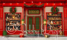 a red store front with christmas decorations and lights