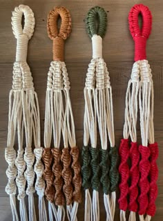 four different colored ropes tied together on a wooden surface