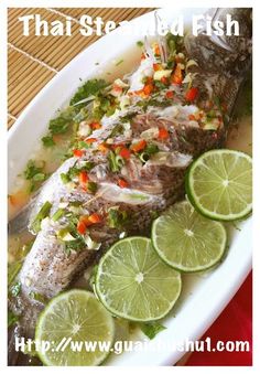 fish with limes and garnishes on a plate