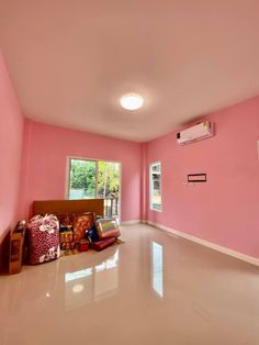 a room with pink walls and white floors