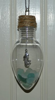 a glass jar filled with sea glass sitting on top of a door