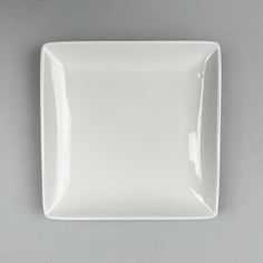 a square white plate sitting on top of a table