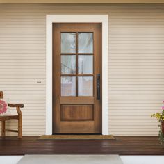 the front door to a house with a chair and flowers