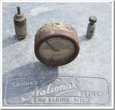 an old parking meter sitting in the snow next to some screwdrivers and poles