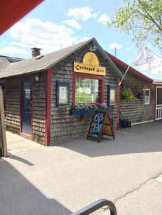 the outside of a small building with a sign on it