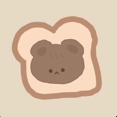 a piece of bread with a brown bear face on it's side, in front of a beige background