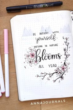 an open notebook with some writing on it next to pens and pencils that say, be patient with yourself nothing in nature blooms all year