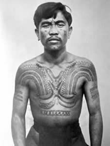 an old photo of a man with tattoos on his body and chest, standing in front of a white background