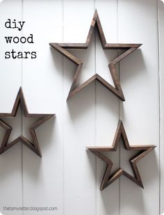 three wooden stars are hanging on the wall