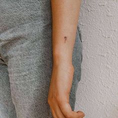 a person with a small tattoo on their arm