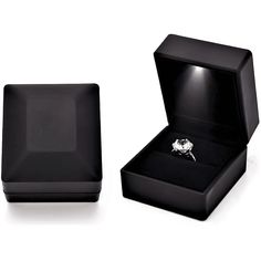 an open black box with a ring in it