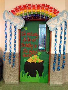 a door decorated with rainbows, clouds and a pot of gold