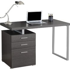 a computer desk with a laptop on top of it and a lamp next to it