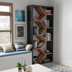 a living room filled with lots of furniture and bookshelves next to a window