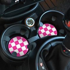 the steering wheel knobs are decorated with black and white checkerboard designs on them