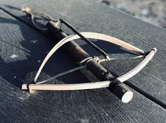 an old bow and arrow on a wooden table