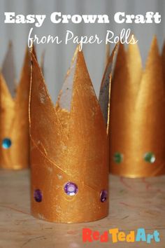 some paper crowns are sitting on a table with the words easy crown craft from paper rolls