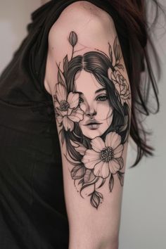 Woman's upper arm tattoo featuring a realistic portrait of a woman's face surrounded by flowers and leaves. Fierce Feminine Tattoos, Tattoo Of A Woman Face, Woman’s Face Tattoo, Woman Flower Tattoo, Floral Stomach Tattoo, Female Face Tattoo Design, Beautiful Woman Tattoo, Tattoo Of Face, Tattoo Inspiration Women