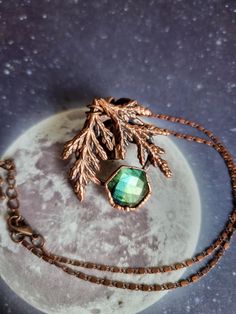 I created this pendant with my boundless love for nature and fantasy in mind. This pendant was made with a beautiful faceted labradorite that reflects blue-green hues, reminiscent of the tree it came from, and real dried cypress leaves encased in copper. The electroforming (or electroplating) process involves immersing a piece covered with conductive paint into an acid solution to deposit a layer of copper using a low electrical current. It is impossible to control or direct the copper during it Cypress Leaves, Copper Uses, Electroplating Process, Clear Nail Polish, Electroformed Jewelry, Crystal Necklaces, Green Hues, Chain Lengths, Crystal Necklace