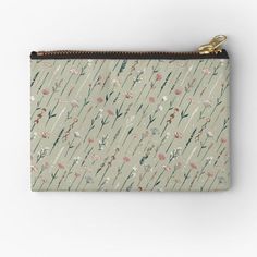 a small zipper pouch with flowers and leaves printed on the front, along with two zip closures