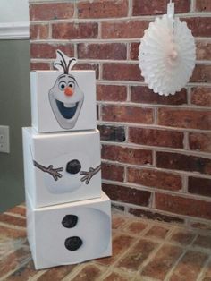 a stack of three boxes painted to look like snowmen