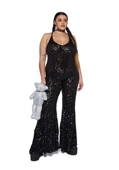 cuz you’ve got them mesmerized. This jumpsuit has a stretchy sequin construction, flare pants, an open back, and cross straps. Black Stretch Jumpsuits And Rompers With Sequins, Sequin Backless Jumpsuits And Rompers For Night Out, Sleeveless Disco Jumpsuit For Night Out, Disco Attire, Plus Size Disco Outfit, Black Stretch Sequined Jumpsuits And Rompers, Plus Size Sequin Jumpsuit, 70s Disco Party Outfit, Plus Size Rave