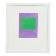 a purple and green square in a white frame on a white wall with a black border