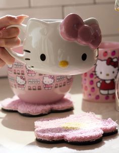 a hello kitty tea cup and coaster on a table