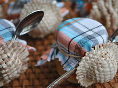 some very pretty little silverware with plaid designs on them