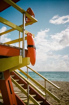 lifeguard stand on the beach with life preserver attached to it