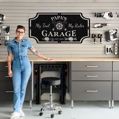 a woman standing in front of a garage sign